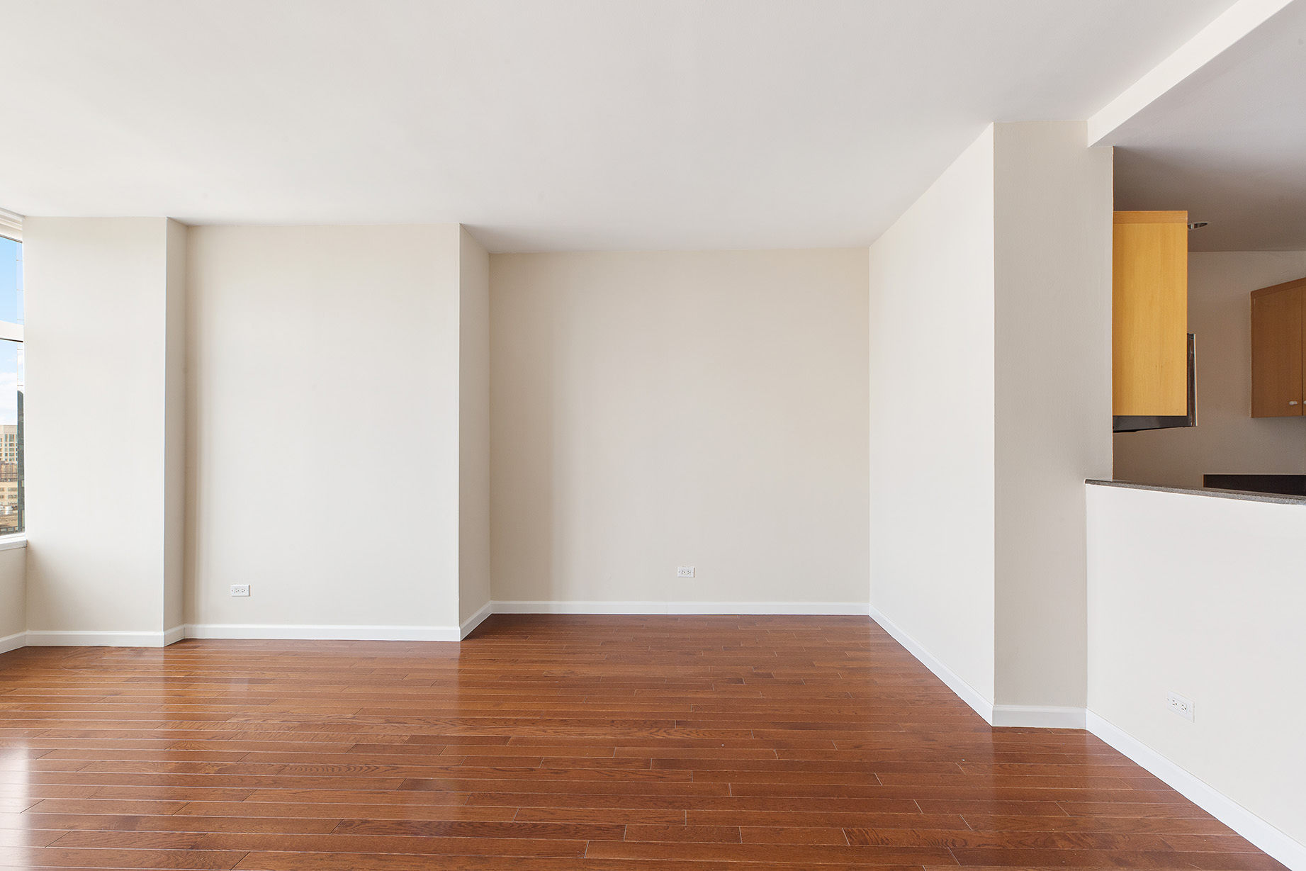 160 West 66th Street, Unit 33A Manhattan, NY 10023 - Photo 7 of 11 a view of an empty room with wooden floor and a window