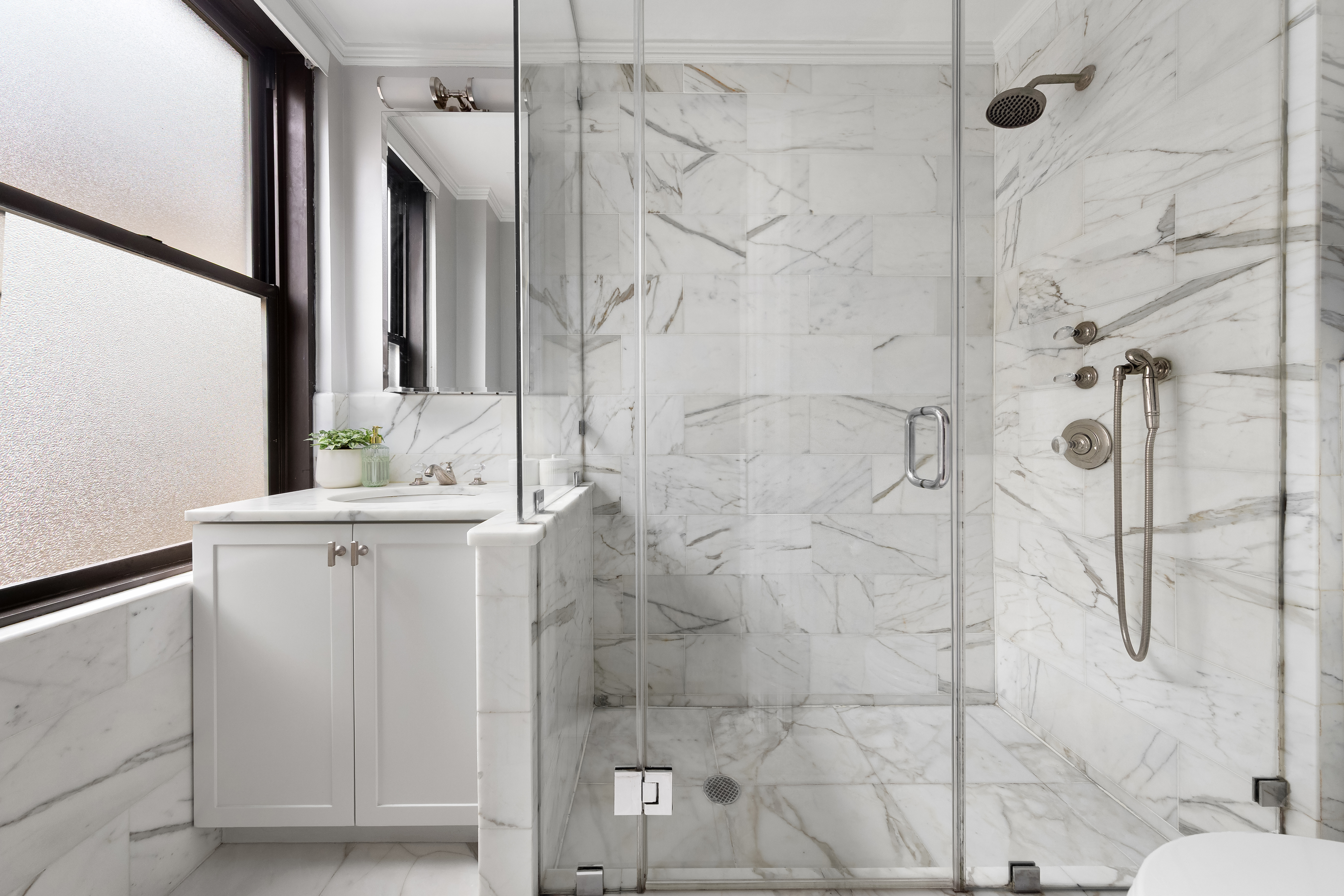 905 West End Avenue, Unit 81 Manhattan, NY 10025 - Photo 9 of 15 a bathroom with a sink vanity and shower