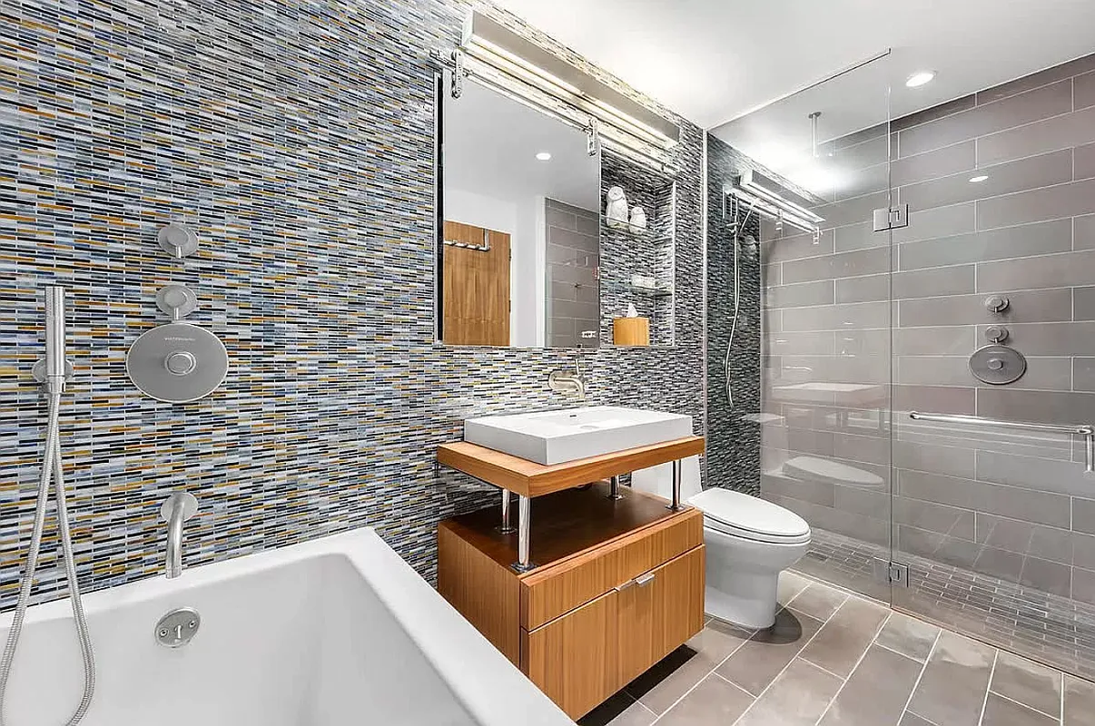 2280 Frederick Douglass Boulevard, Unit 6C Manhattan, NY 10027 - Photo 6 of 7 a bathroom with a sink a toilet a mirror and shower