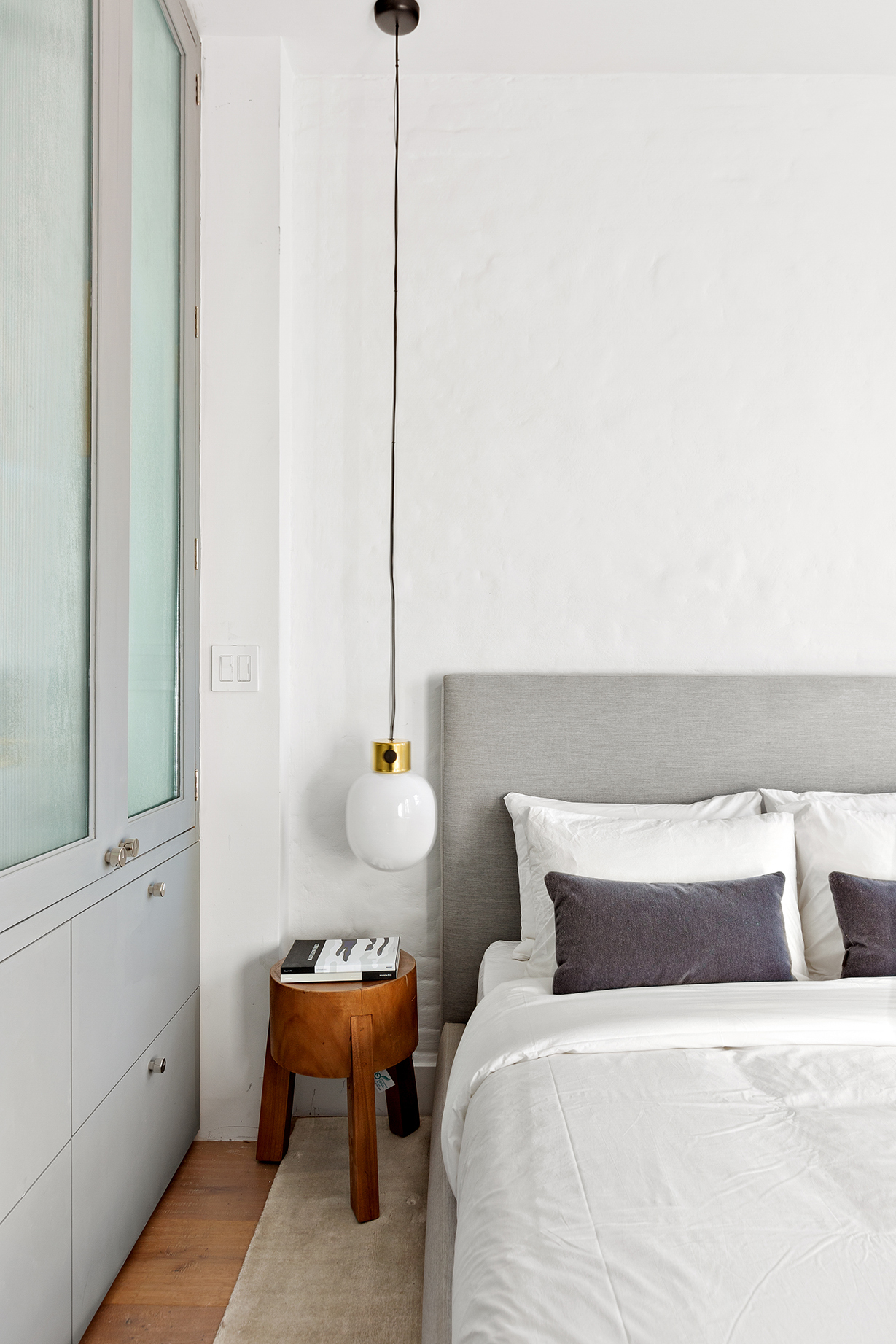 110 Thompson Street, Unit 6E Manhattan, NY 10012 - Photo 5 of 8 a bedroom with a bed and a chandelier