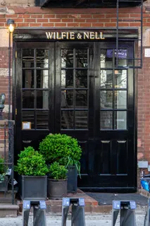 a couple of potted plants in front of door