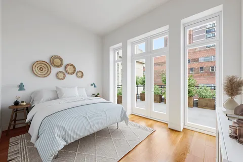 a bedroom with a large bed and a large window