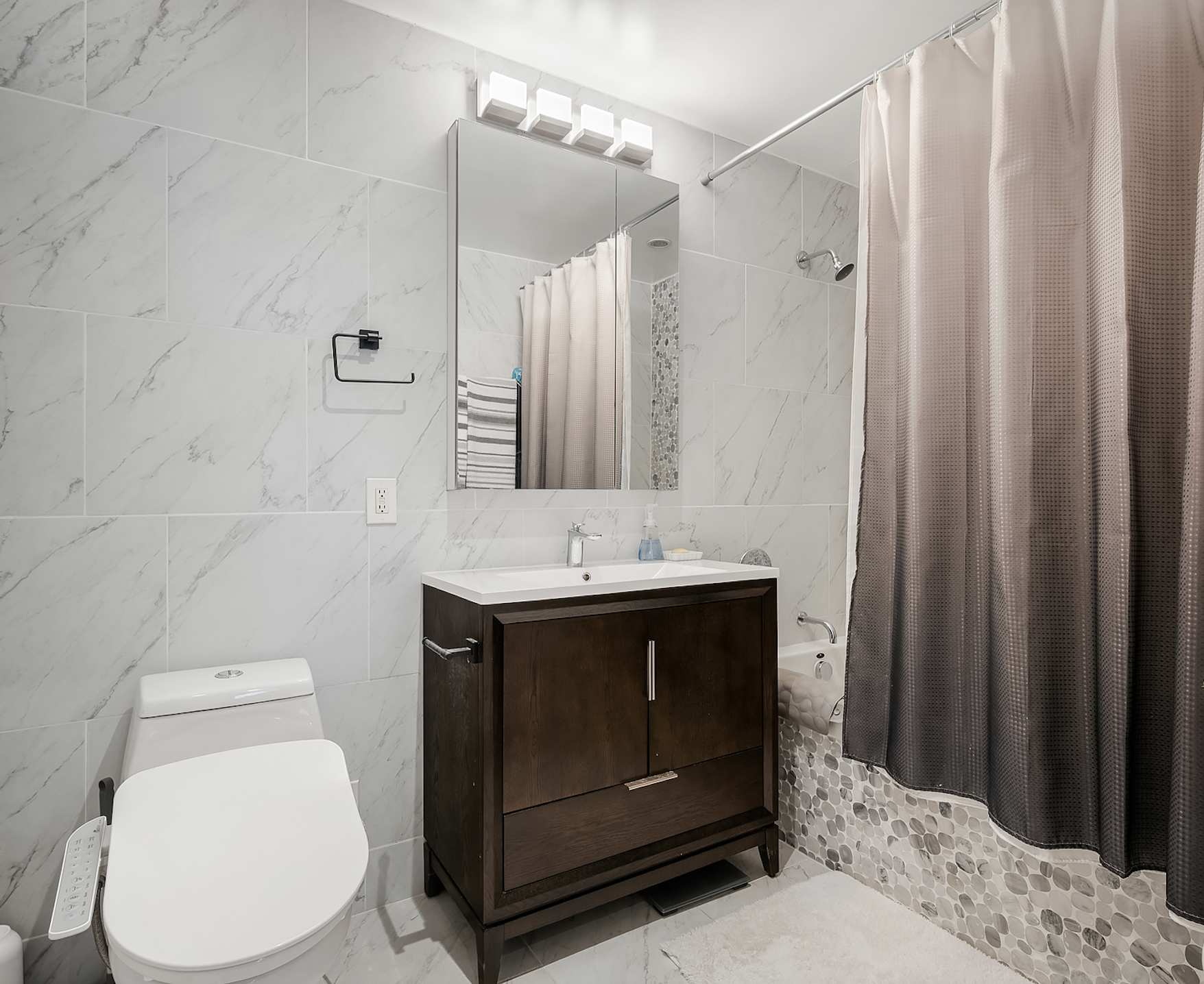 41-26 27th Street, Unit 5E Queens, NY 11101 - Photo 7 of 12 a bathroom with a sink toilet and shower