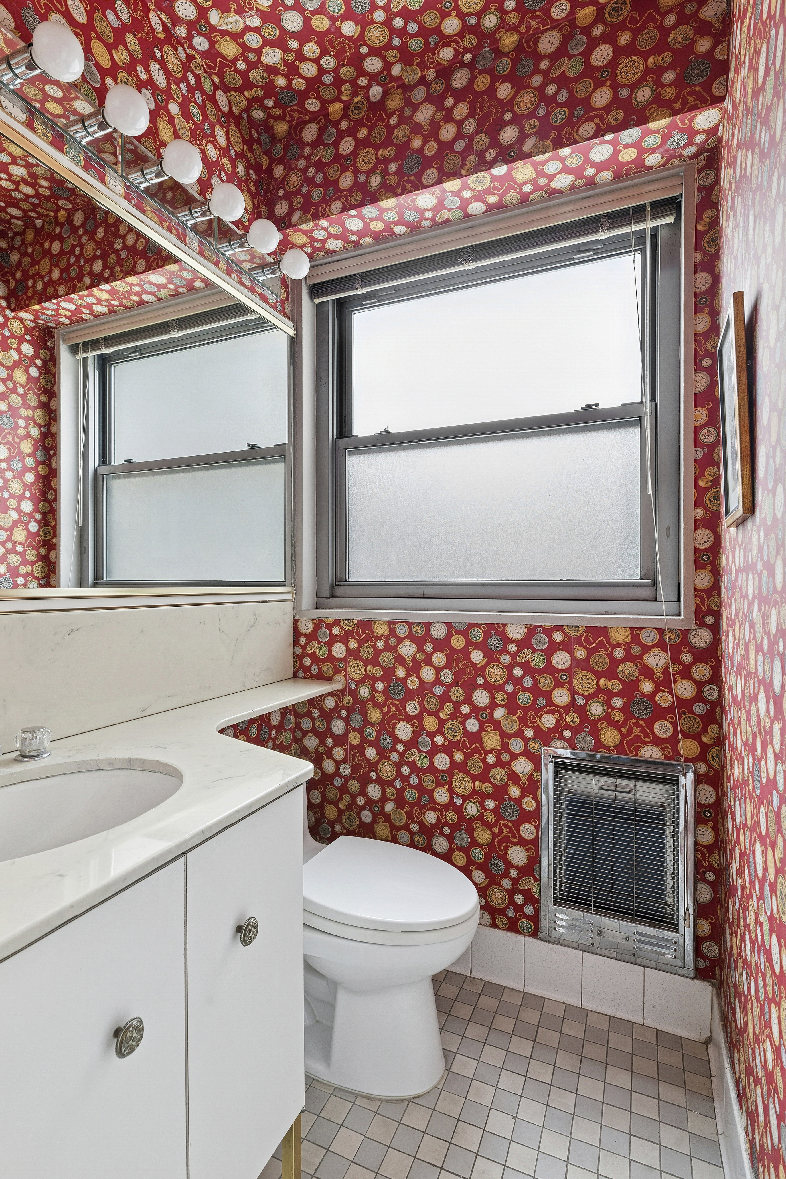 400 East 56th Street, Unit 4R Manhattan, NY 10022 - Photo 7 of 9 a bathroom with a toilet a sink and a window