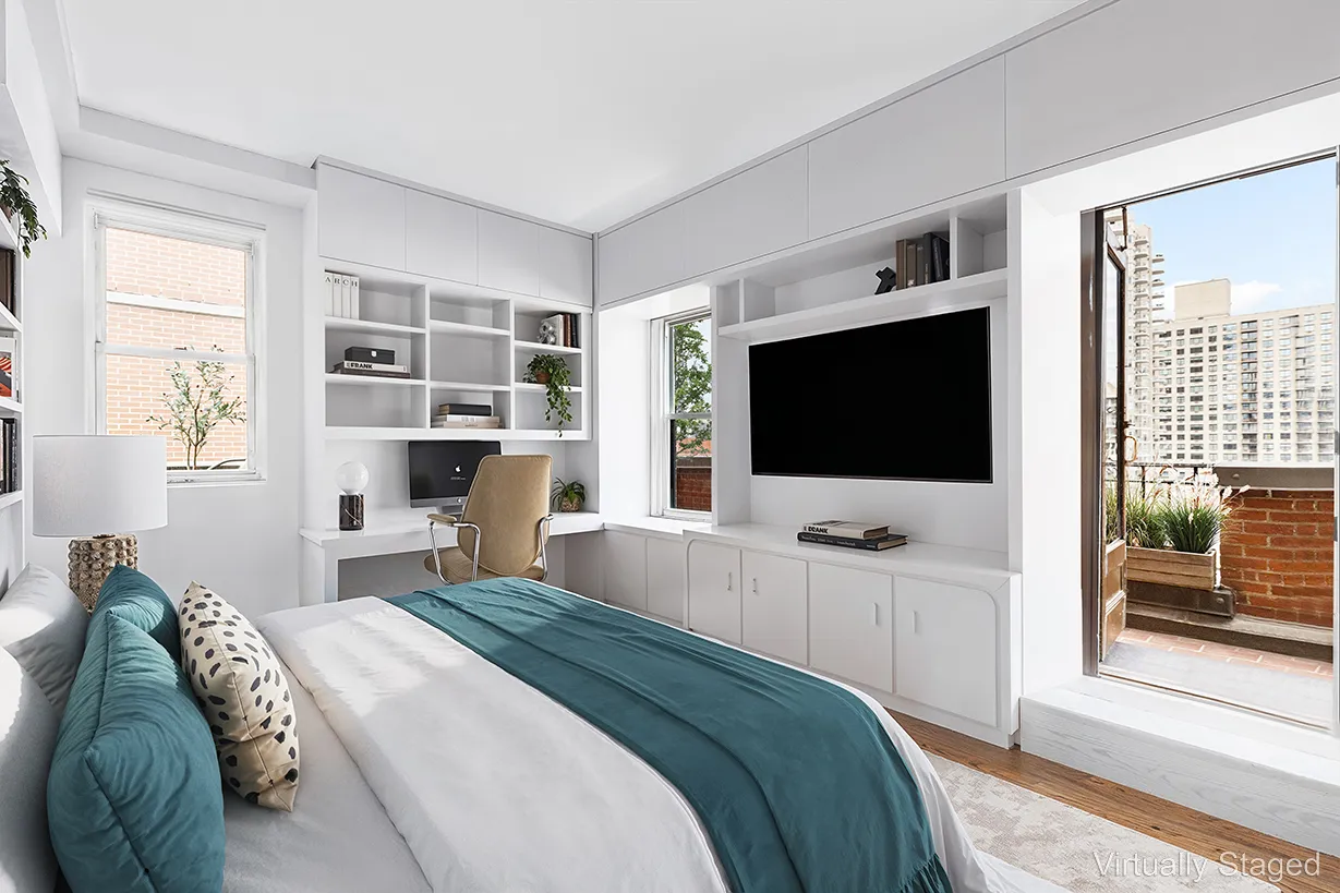 a bedroom with a flat screen television and a bed