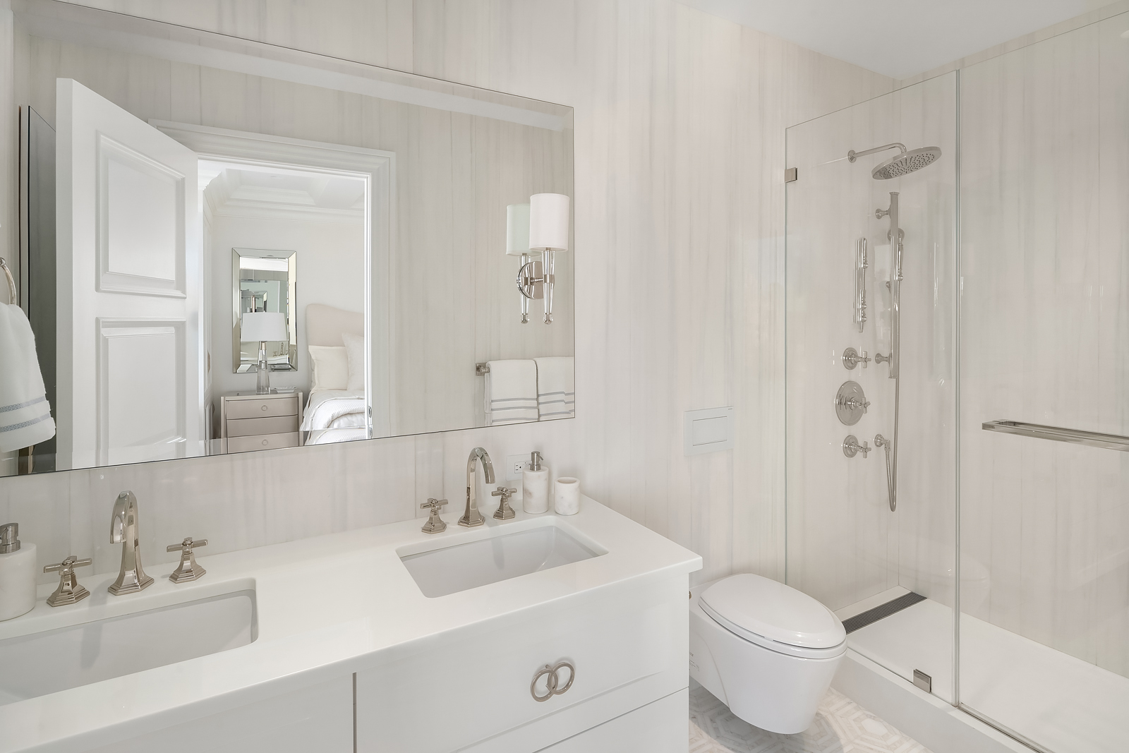 930 5th Avenue, Unit 18A Manhattan, NY 10021 - Photo 11 of 16 a bathroom with a toilet a sink a mirror a shower and vanity