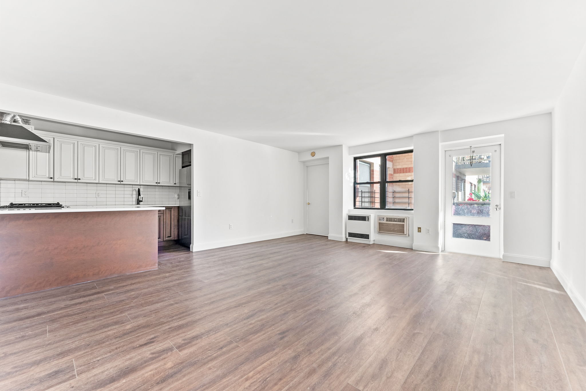 1919 Madison Avenue, Unit 214 Manhattan, NY 10035 - Photo 10 of 19 a view of empty room with wooden floor and window