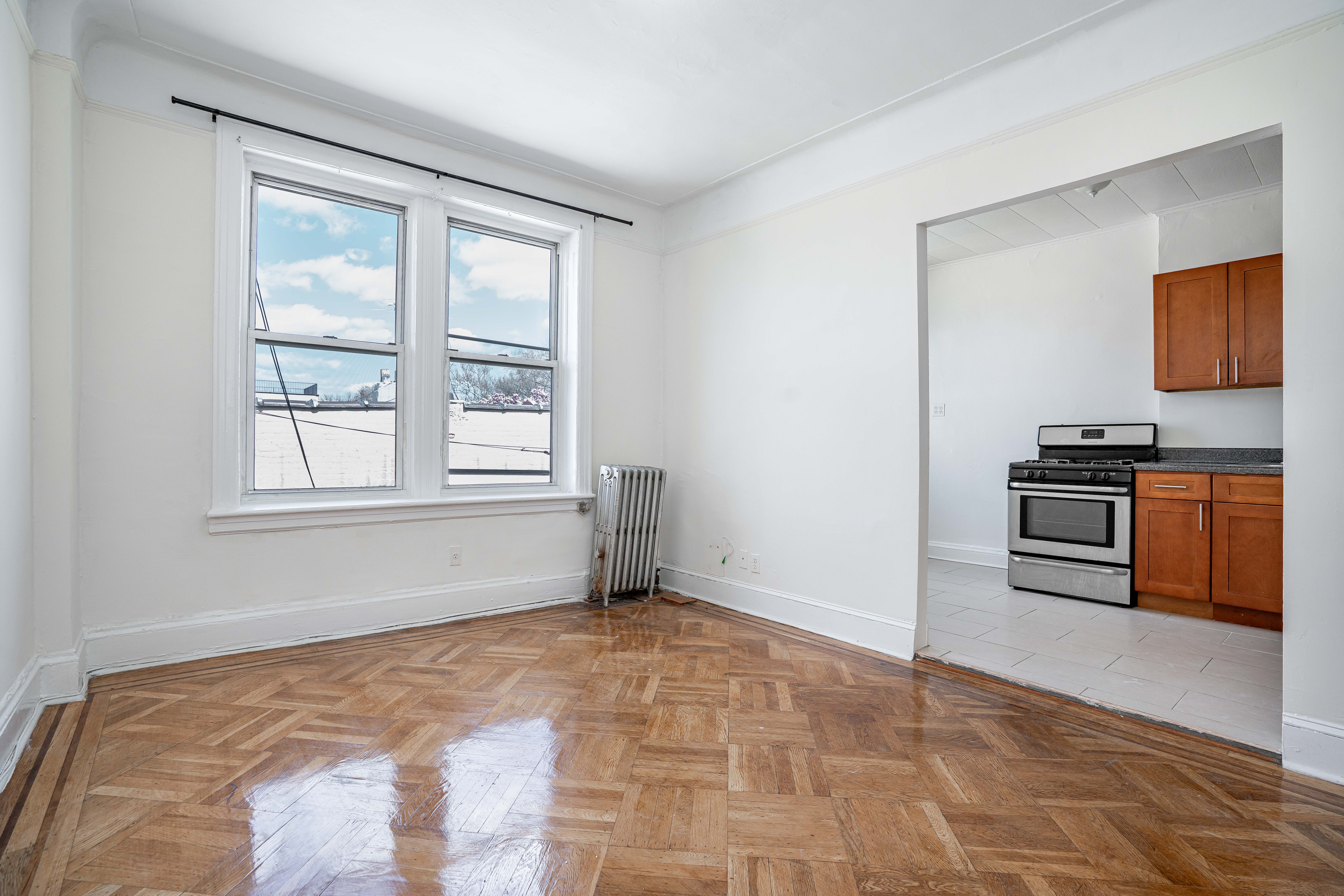 27-15 24th Avenue, Unit 2 Queens, NY 11105 - Photo 3 of 10 a view of an empty room with a window