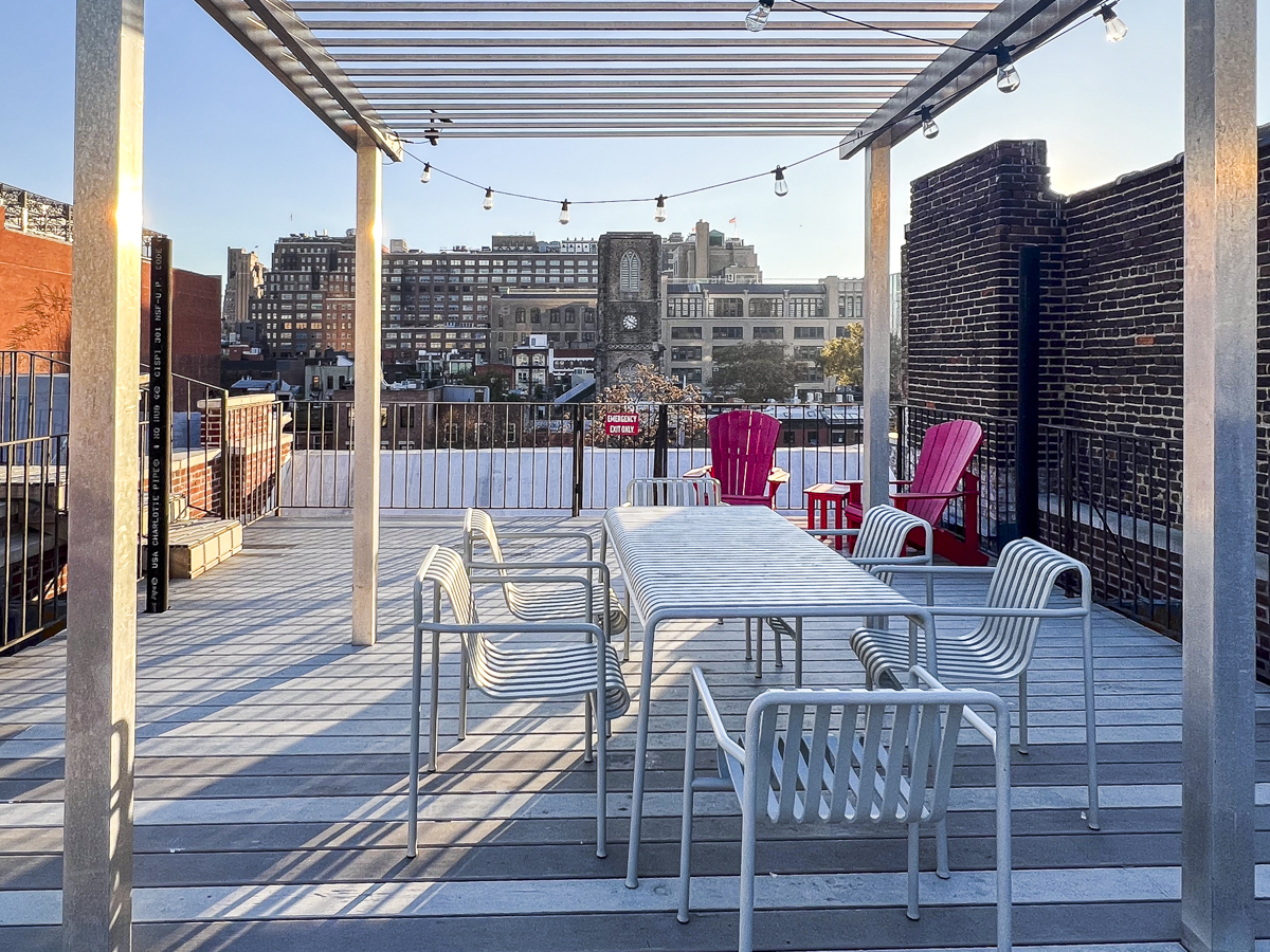 335 West 21st Street, Unit 4FE Manhattan, NY 10011 - Photo 8 of 11 a view of a roof deck with table and chairs
