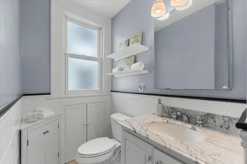 a bathroom with a shower a toilet and sink