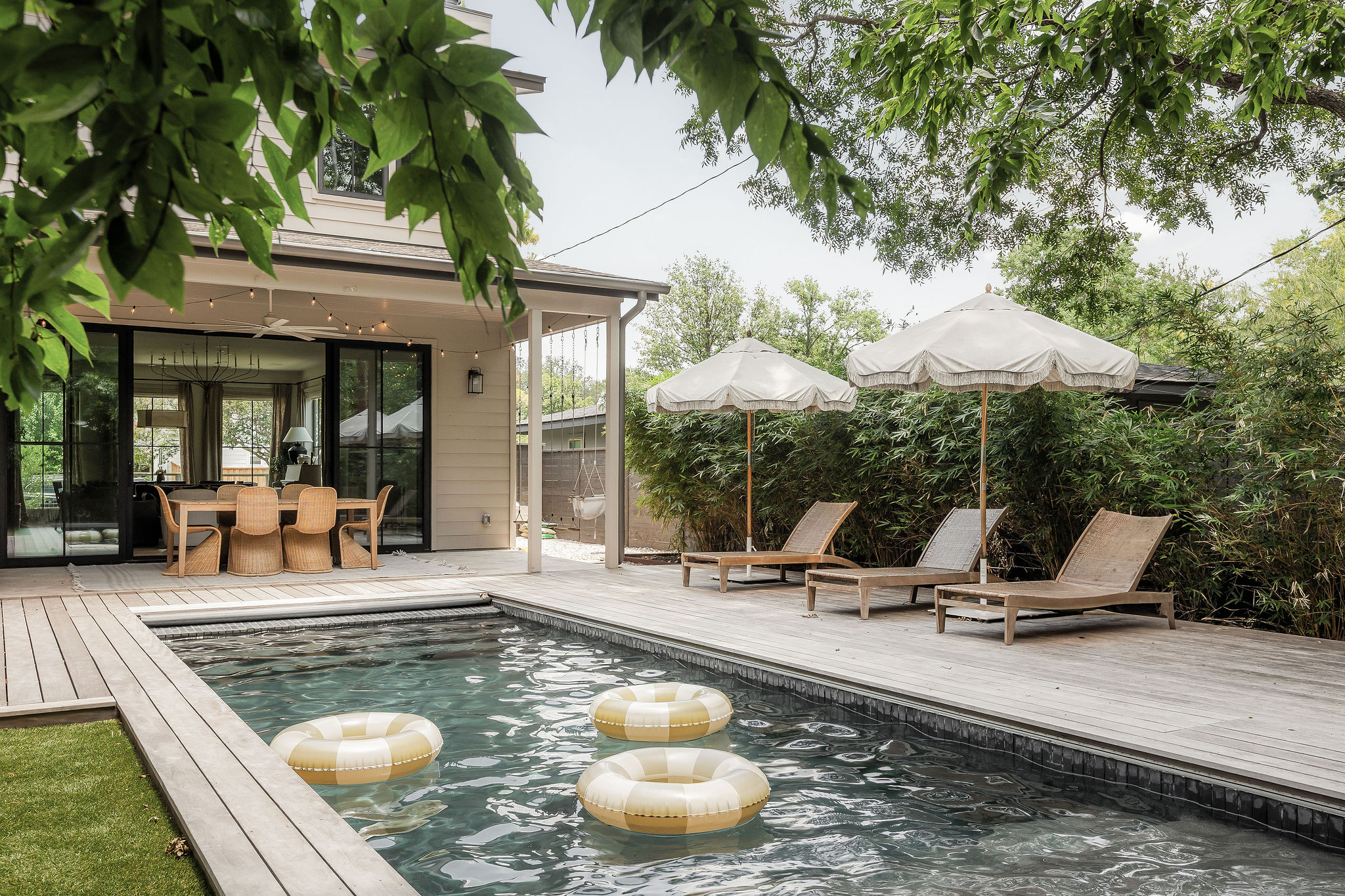 4700 Clawson Road Austin, TX 78745 - Photo 25 of 26 a view of a swimming pool with lawn chairs under an umbrella