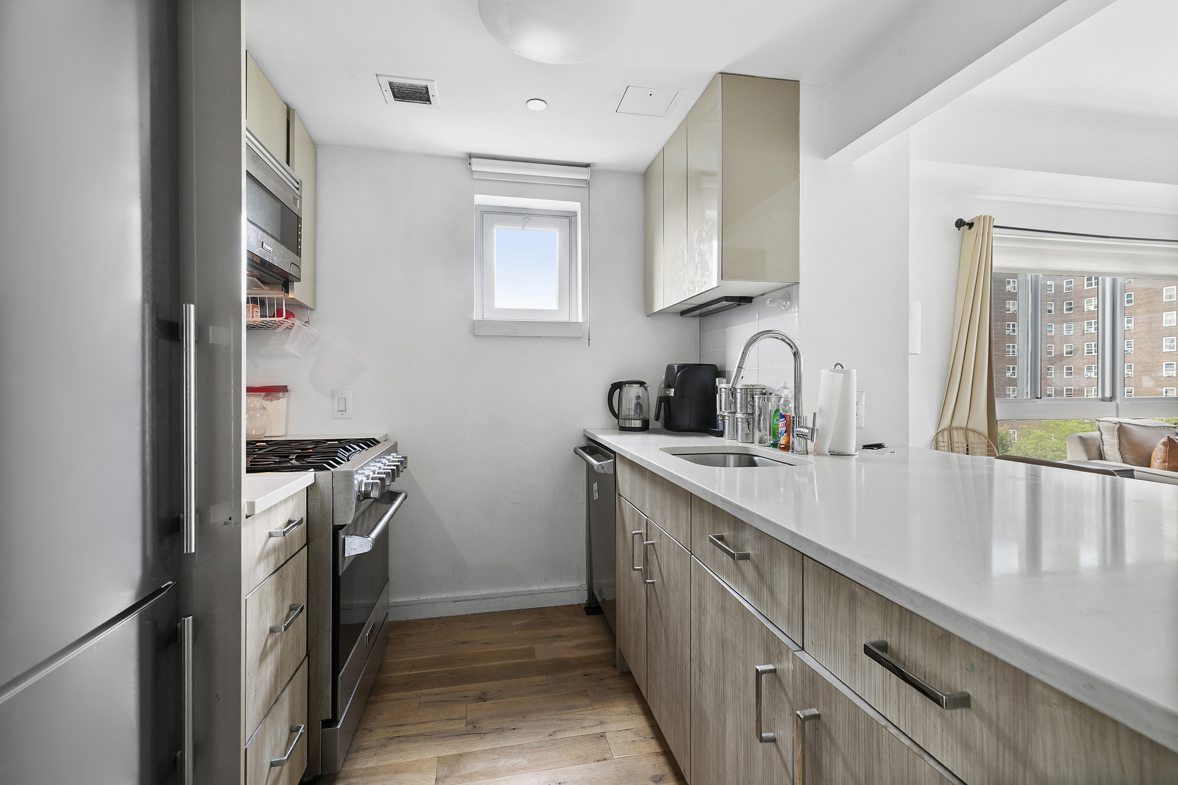 171 West 131st Street, Unit PH3 Manhattan, NY 10027 - Photo 2 of 13 a kitchen with stainless steel appliances granite countertop a sink stove and refrigerator