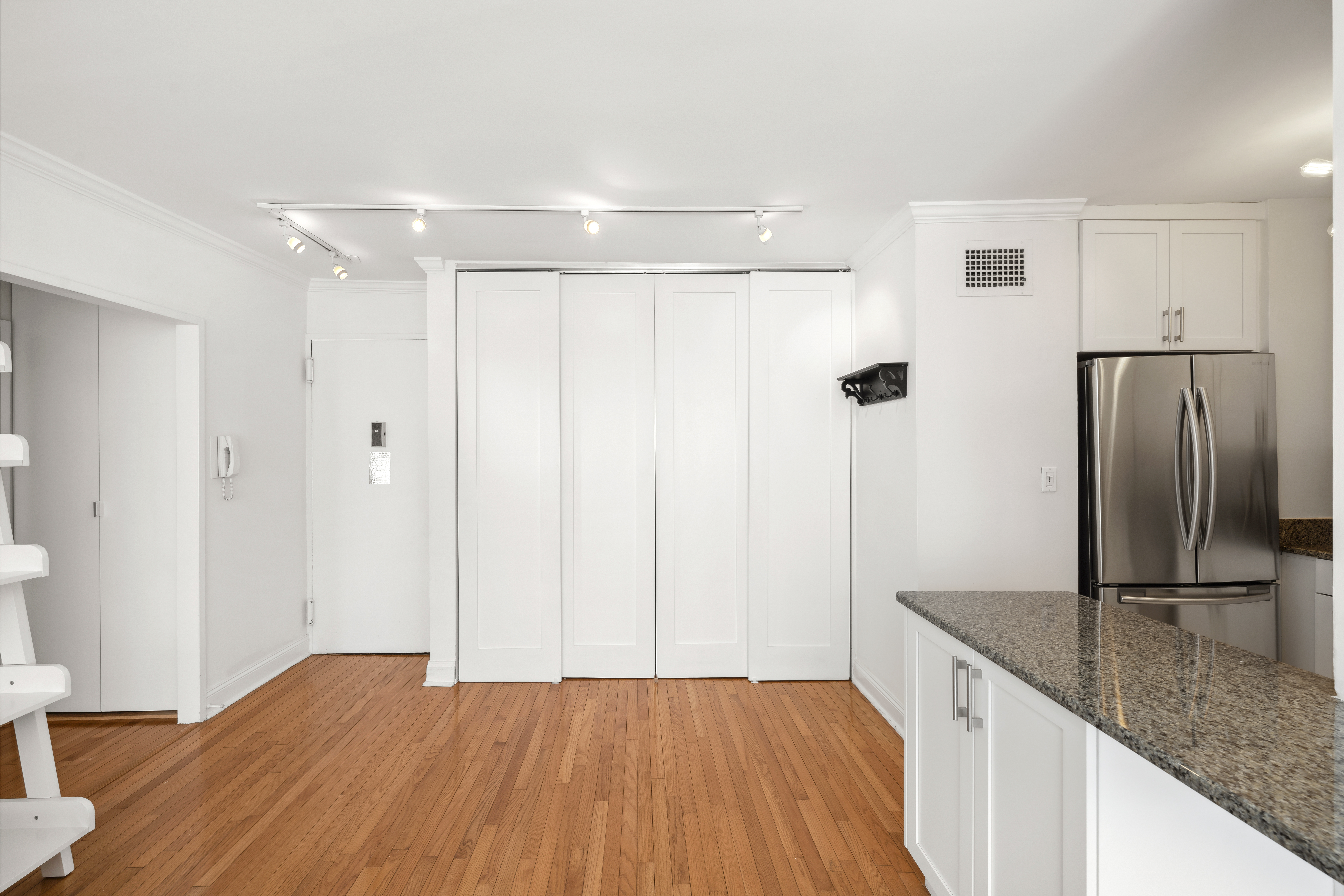301 East 87th Street, Unit 16E Manhattan, NY 10128 - Photo 5 of 16 a kitchen with granite countertop a refrigerator and a sink