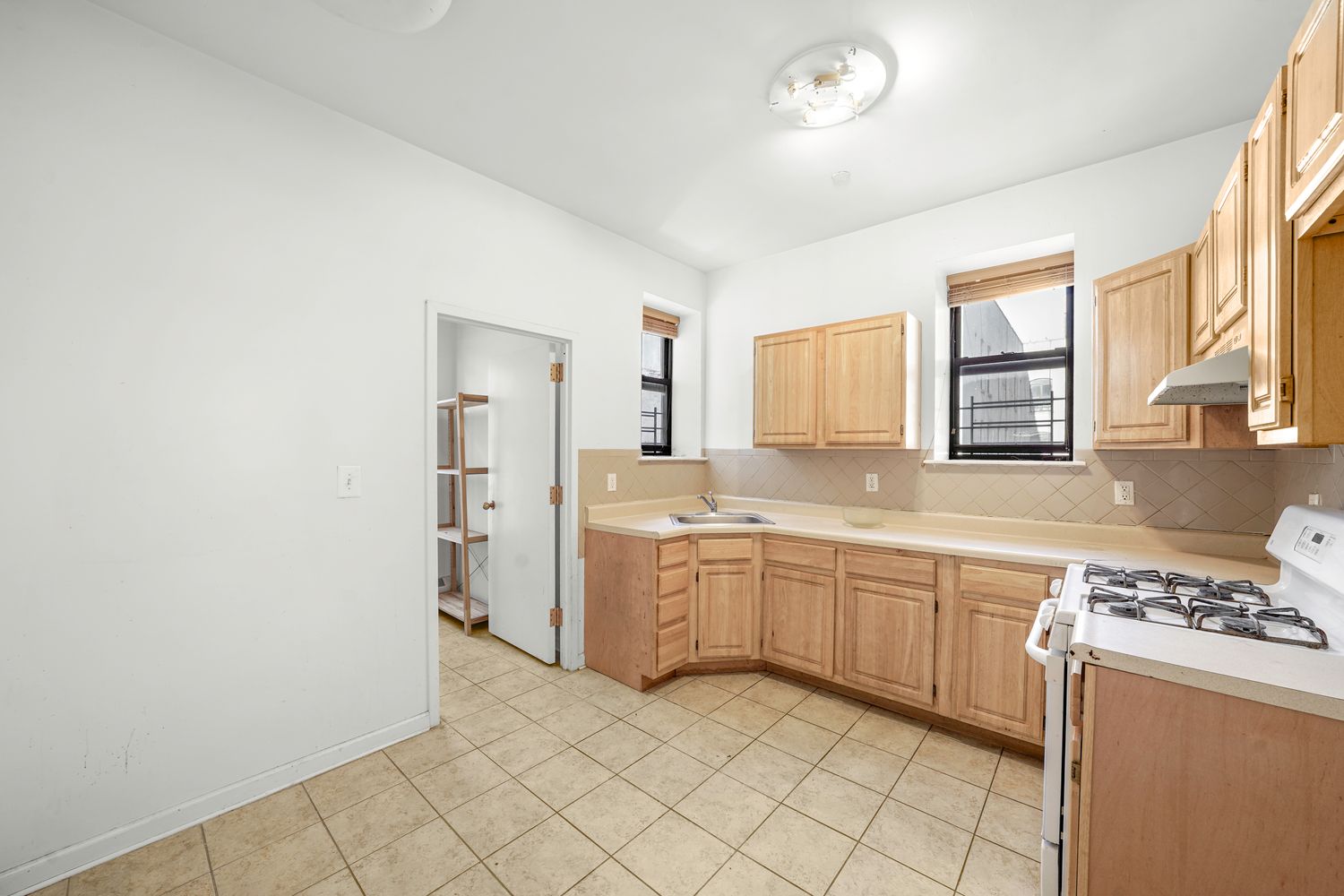 a large kitchen with a stove a sink dishwasher and a refrigerator
