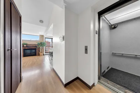 a view of a hallway view with staircase and a living room