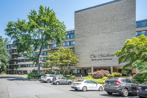 a view of a cars park in front of a building
