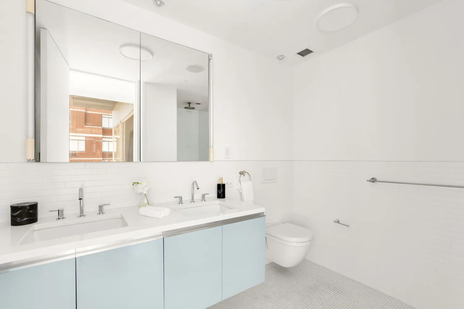 a bathroom with a toilet a sink a mirror and vanity