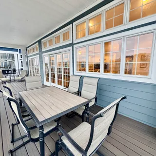 a bathroom with a double vanity sink a toilet a mirror and shower