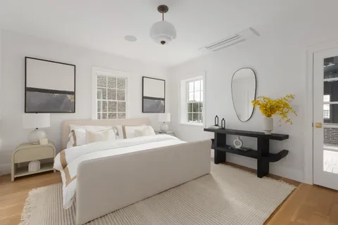 an empty room with wooden floor and closet