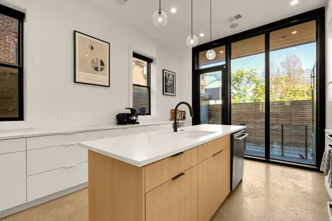 a view of a kitchen with a sink and living room