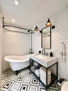 a bathroom with a sink toilet a mirror and bathtub