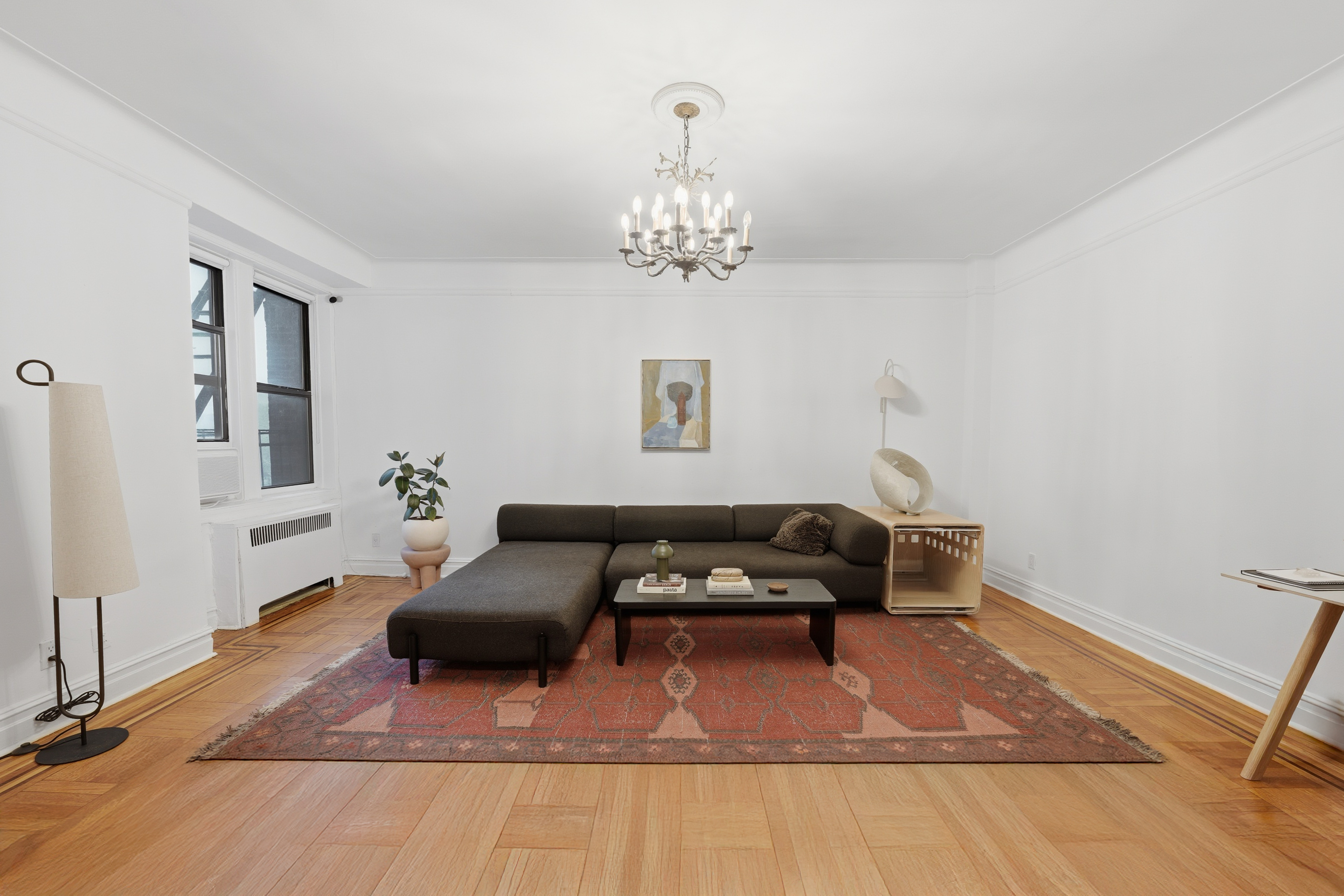 80 Avenue P, Unit D14 Brooklyn, NY 11204 - Photo 2 of 19 a living room with furniture and a chandelier