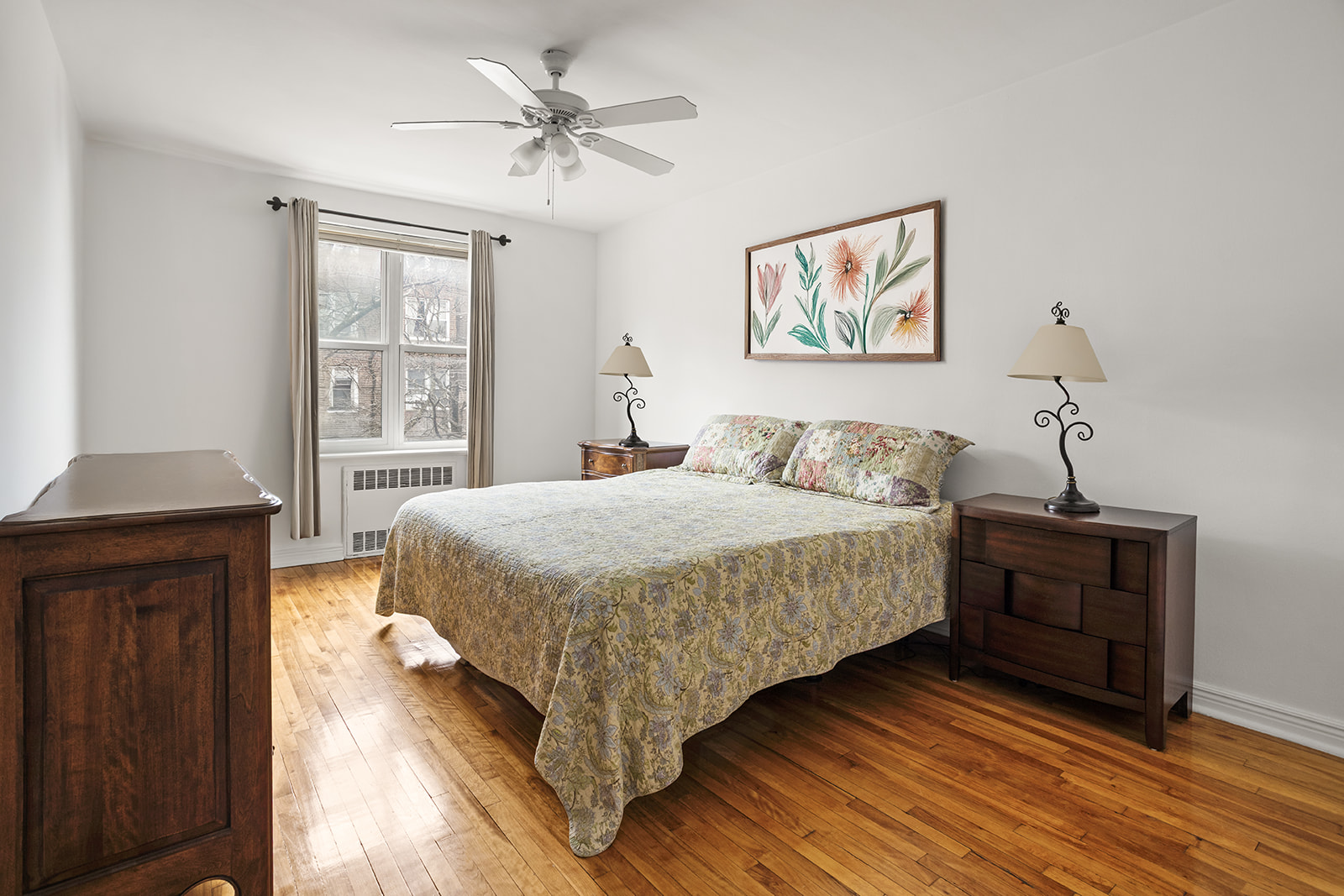 33-16 82nd Street, Unit 4C Queens, NY 11372 - Photo 5 of 13 a bedroom with a bed and wooden floor