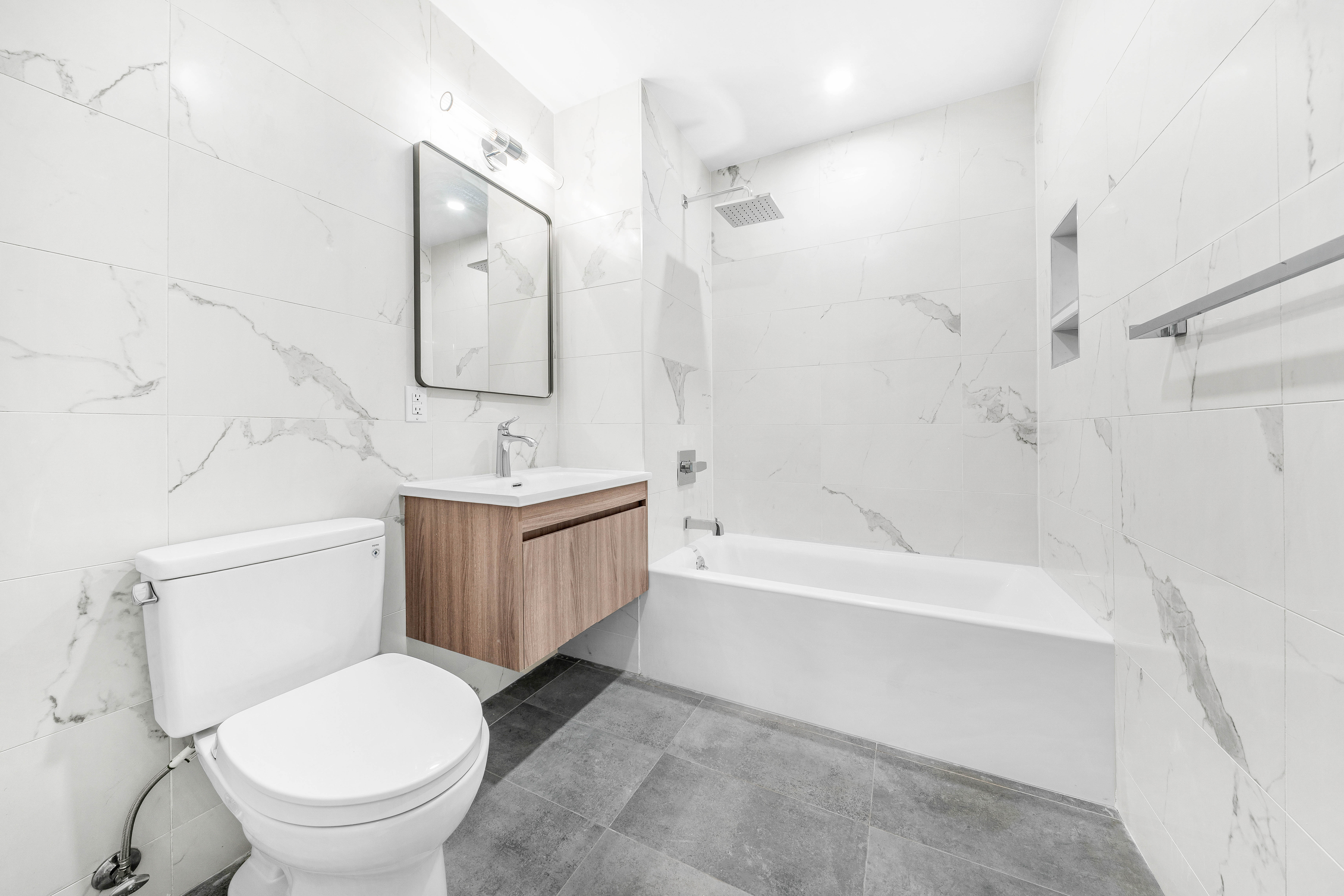 30-24 32nd Street, Unit 4A Queens, NY 11102 - Photo 9 of 22 a bathroom with a toilet sink and bathtub