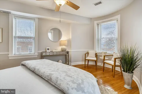 a bedroom with furniture and a large window