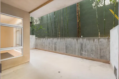 a view of a lobby with a patio and dining table