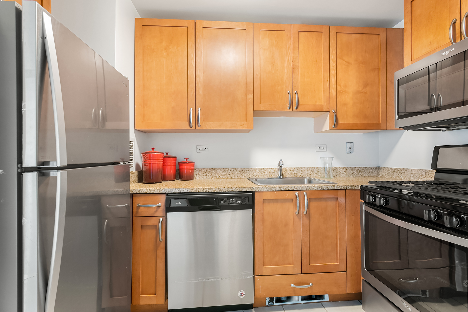 35 West 33rd Street, Unit 28D Manhattan, NY 10001 - Photo 12 of 28 a kitchen with stainless steel appliances granite countertop a refrigerator stove and sink