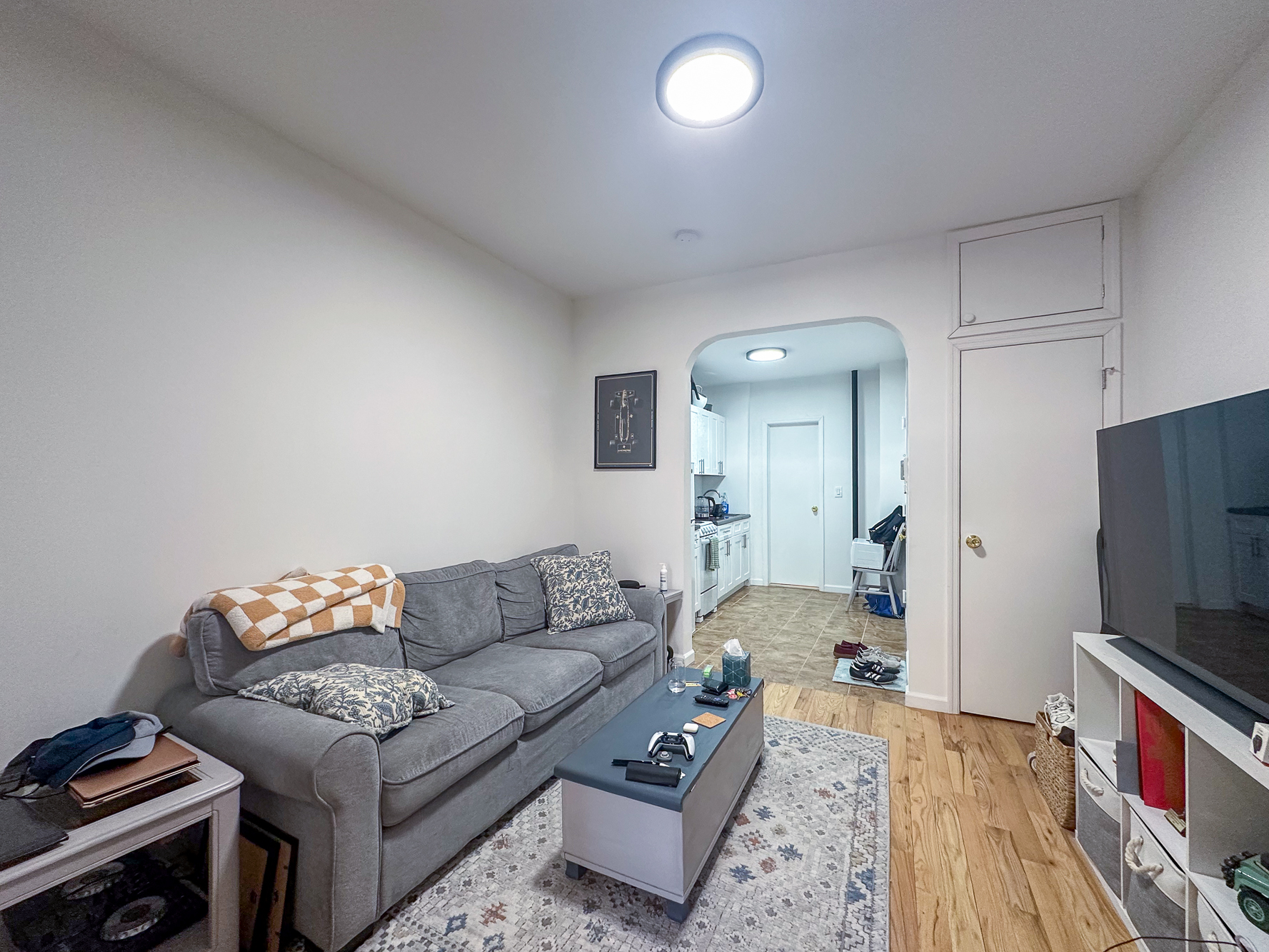 342 East 9th Street, Unit 3B Manhattan, NY 10003 - Photo 4 of 9 a living room with furniture and a flat screen tv