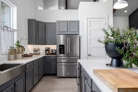 a large kitchen with a table and chairs