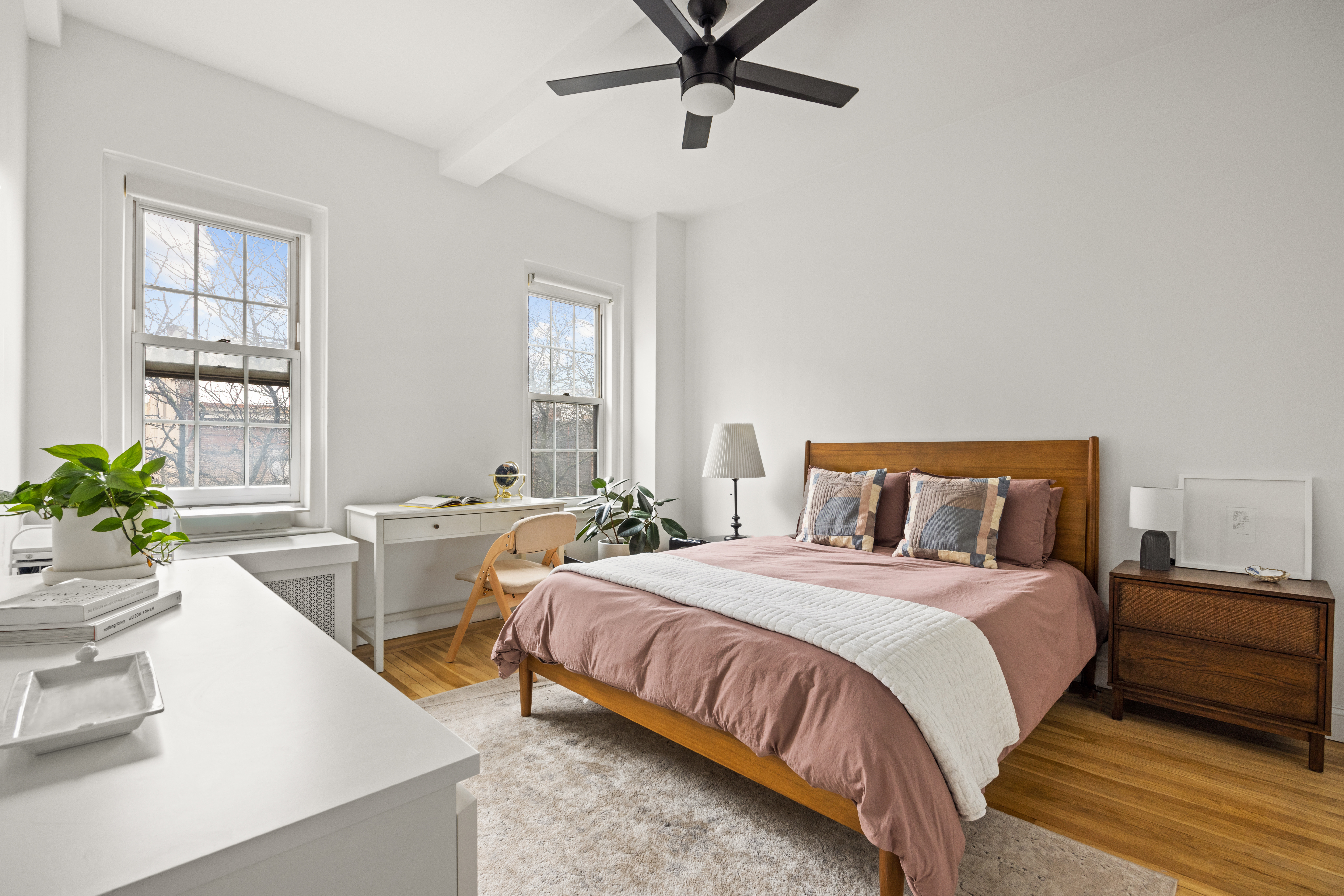 155 Henry Street, Unit 4H Brooklyn, NY 11201 - Photo 6 of 8 a bedroom with a bed and windows