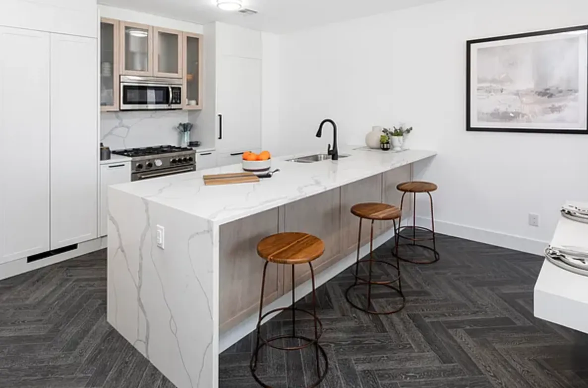 a kitchen with a sink cabinets and wooden floor