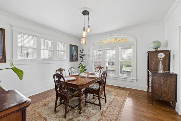 a view of a dining room with furniture and wooden floor