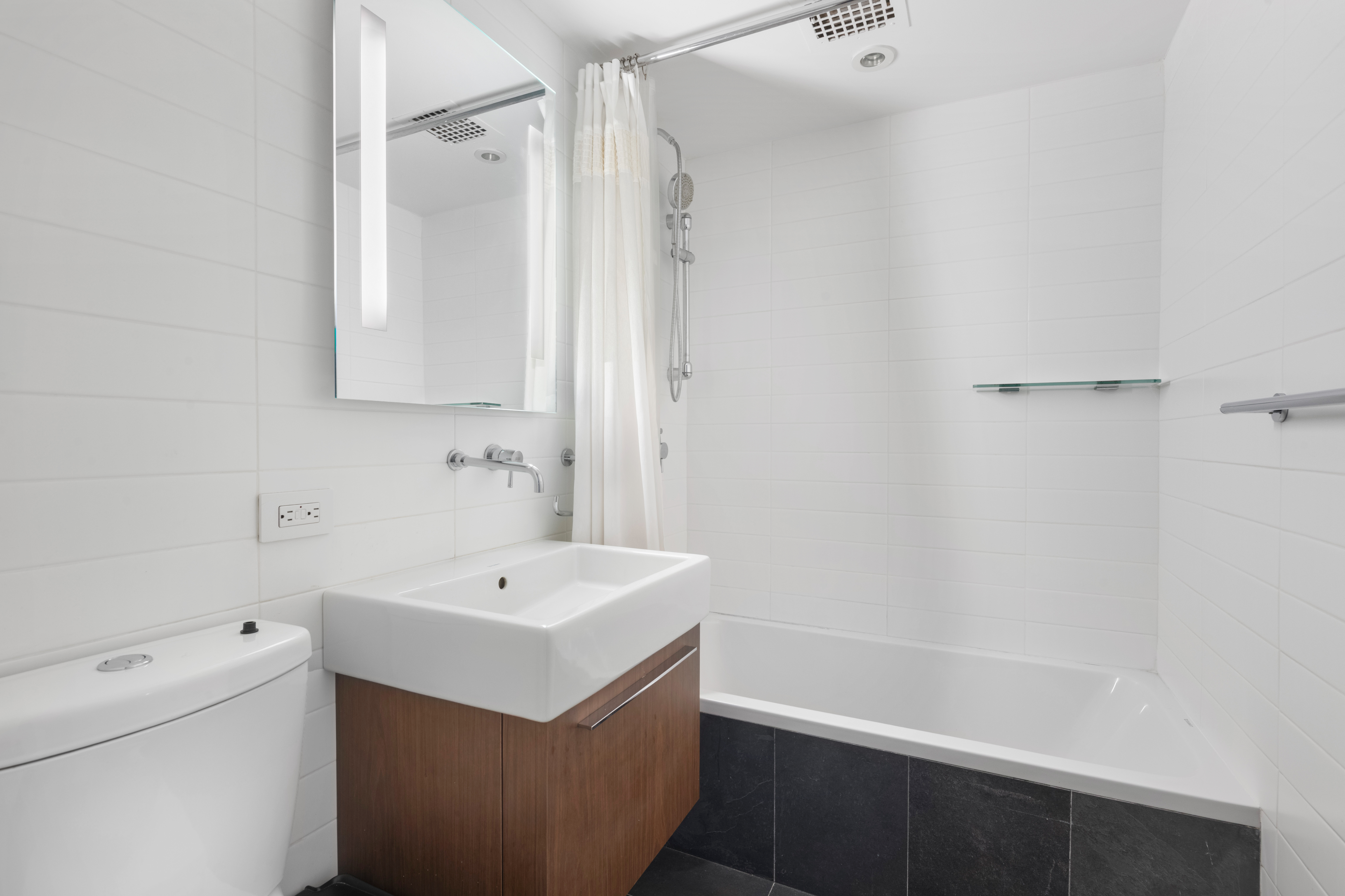 250 West 15th Street, Unit 4CD Manhattan, NY 10011 - Photo 11 of 13 a bathroom with a sink a toilet and shower