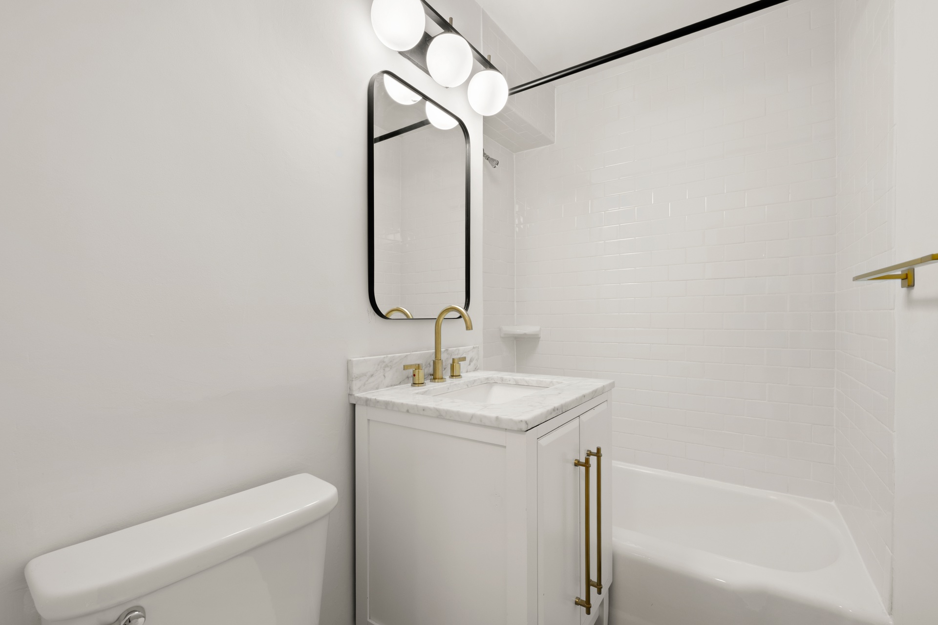 10 West 15th Street, Unit 414 Manhattan, NY 10011 - Photo 8 of 16 a bathroom with a sink a toilet and shower