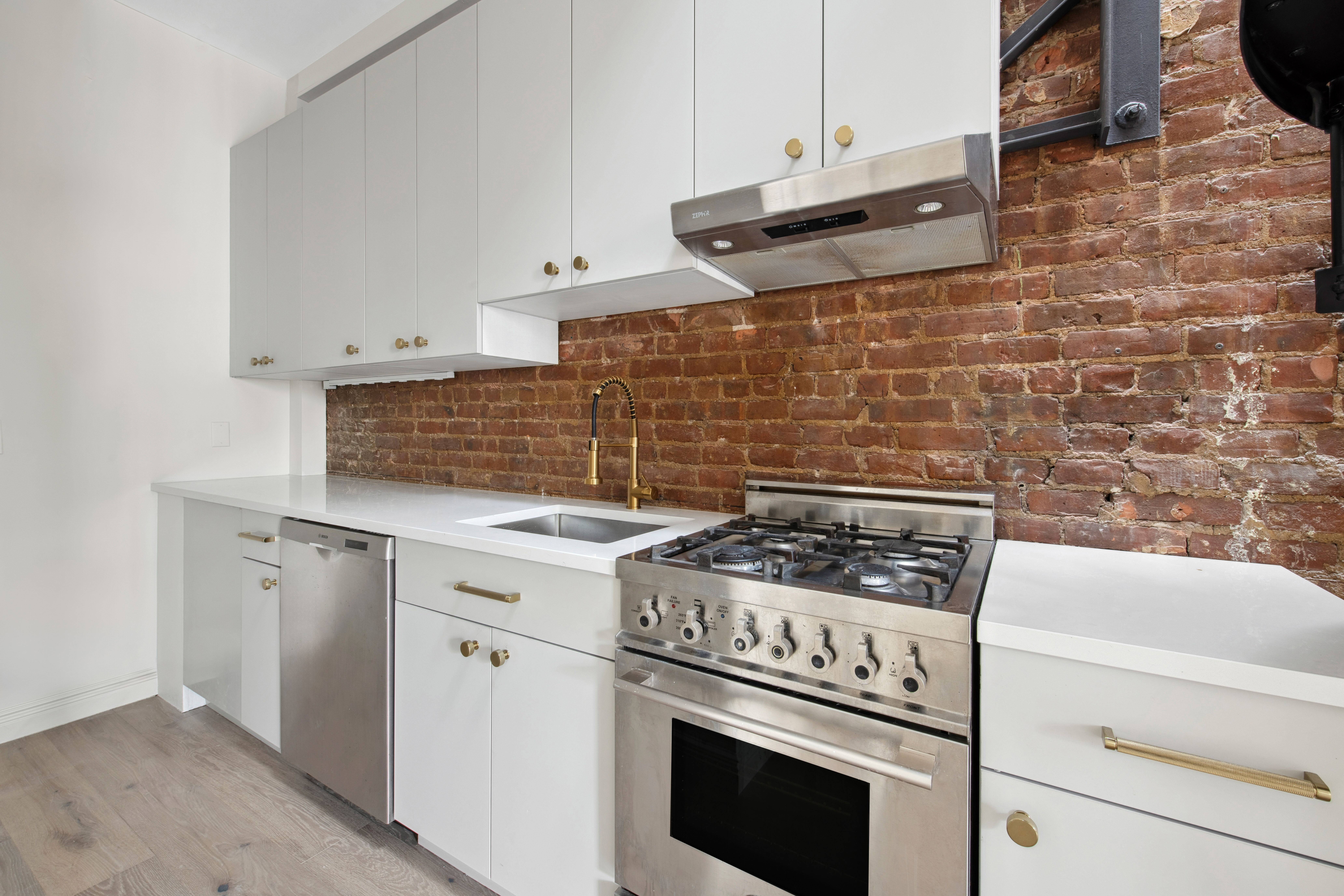 212 East 70th Street, Unit 4B Manhattan, NY 10021 - Photo 6 of 16 a white stove top oven sitting inside of a kitchen