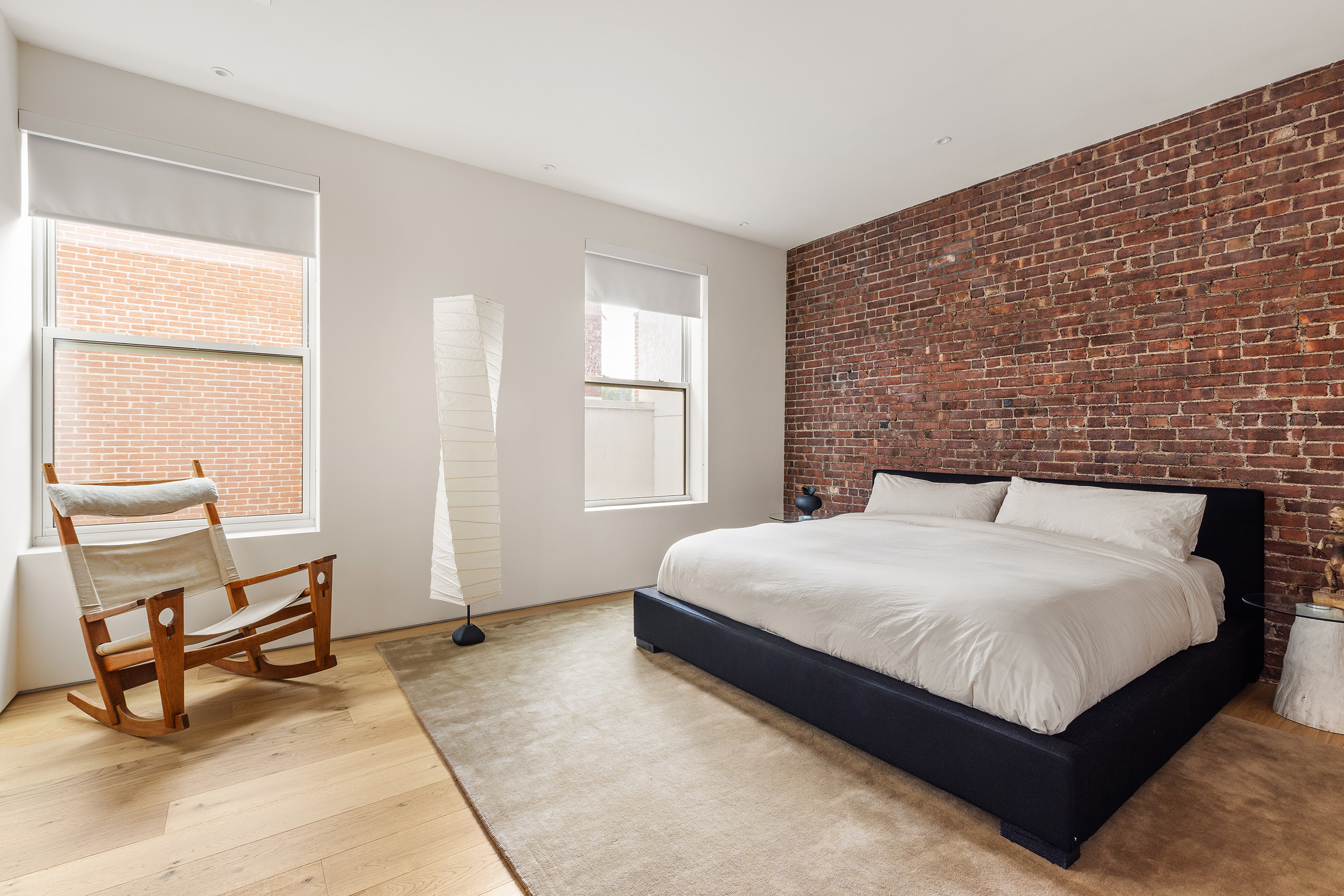 477 Broome Street Manhattan, NY 10013 - Photo 7 of 18 a bedroom with a bed a chair and next to a window
