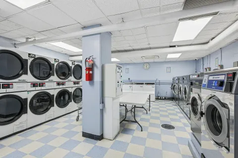 a utility room with sink dryer and washer