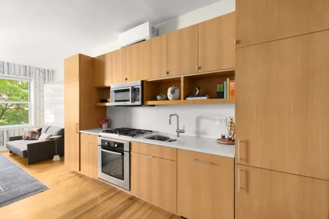 a kitchen with stainless steel appliances a stove a sink and a microwave