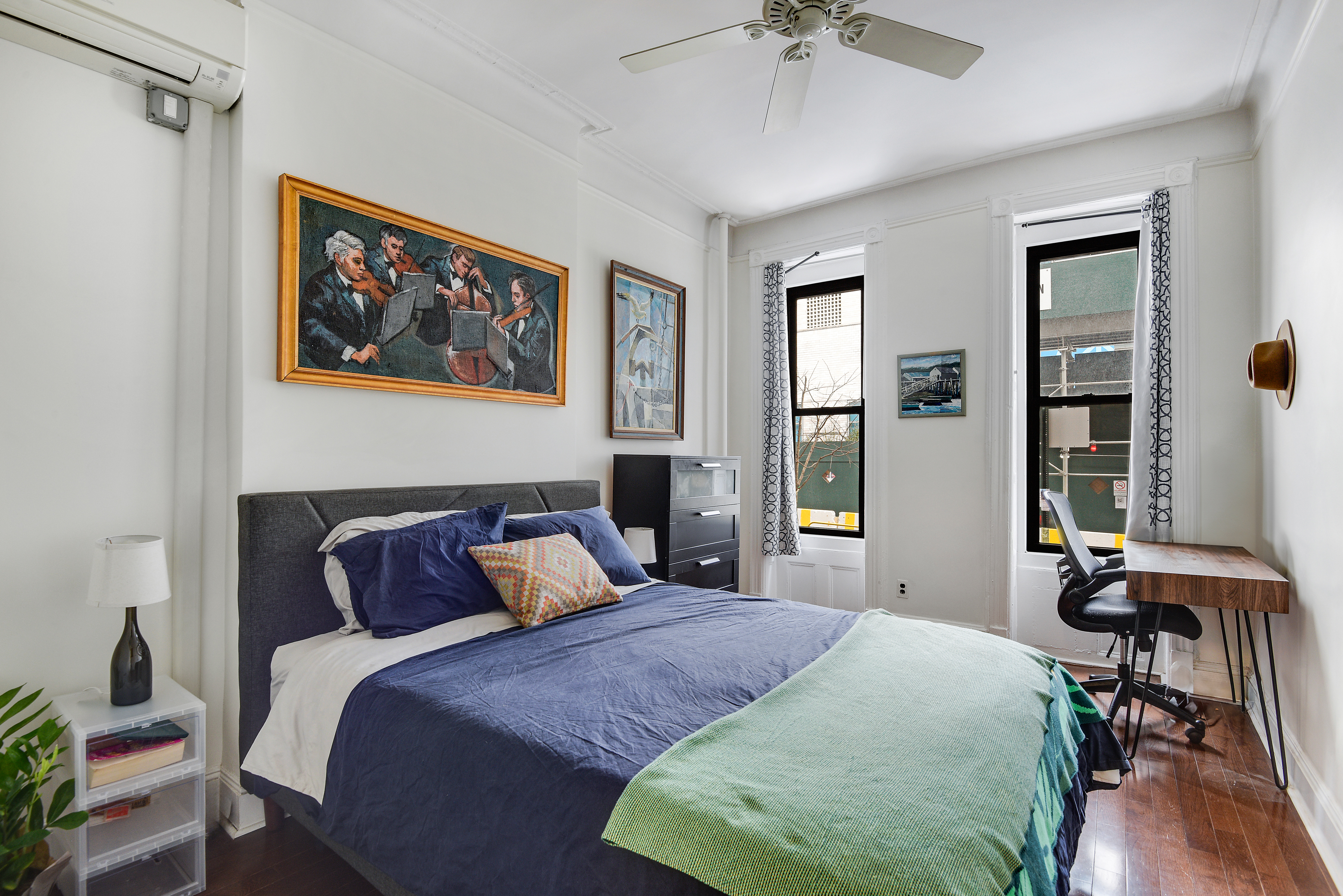 436 East 66th Street, Unit 1W Manhattan, NY 10065 - Photo 12 of 19 a bedroom with a bed and a chandelier