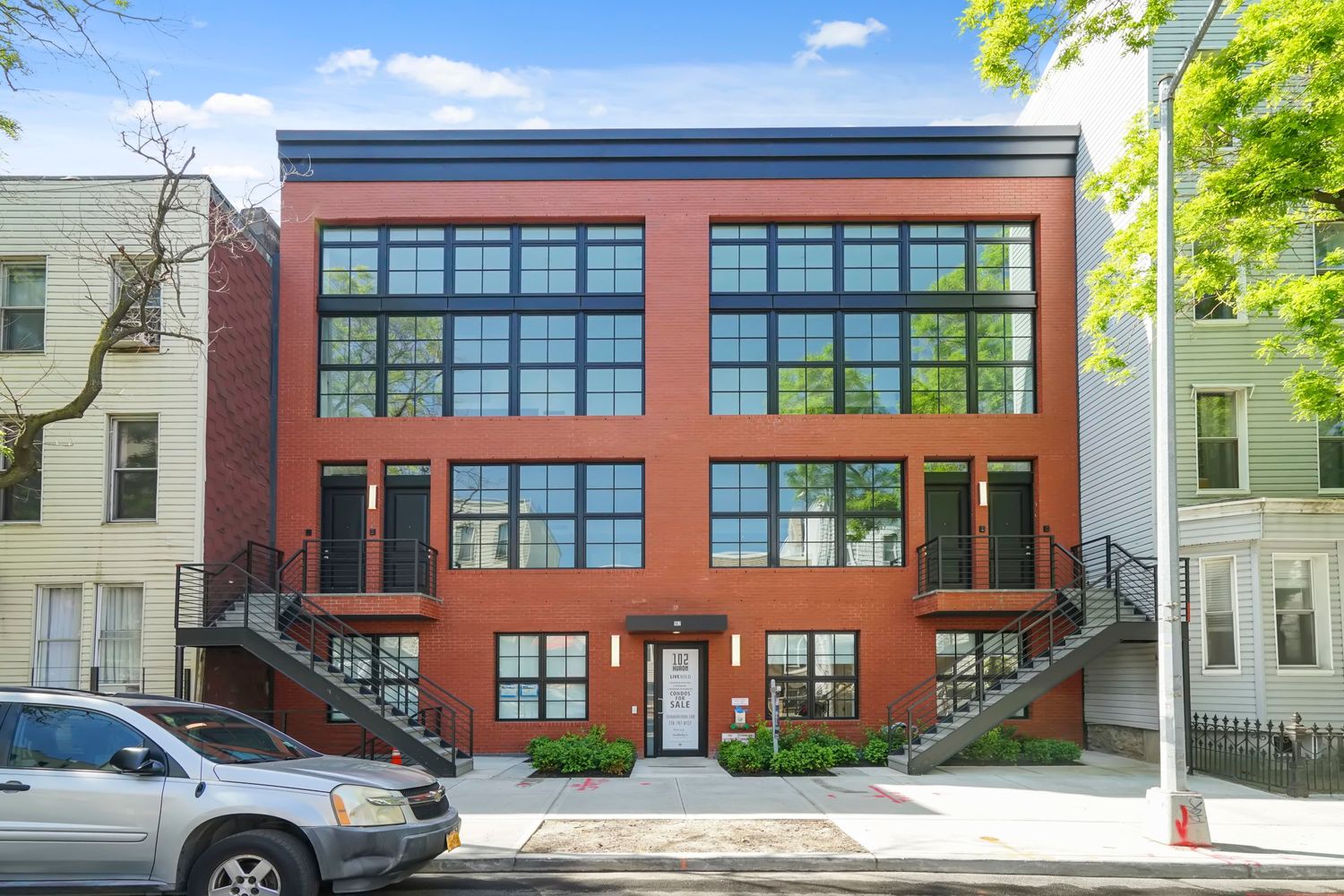 102 Huron Street, Unit 3B Brooklyn, NY 11222 - Photo 16 of 18 a front view of a residential apartment building with a yard