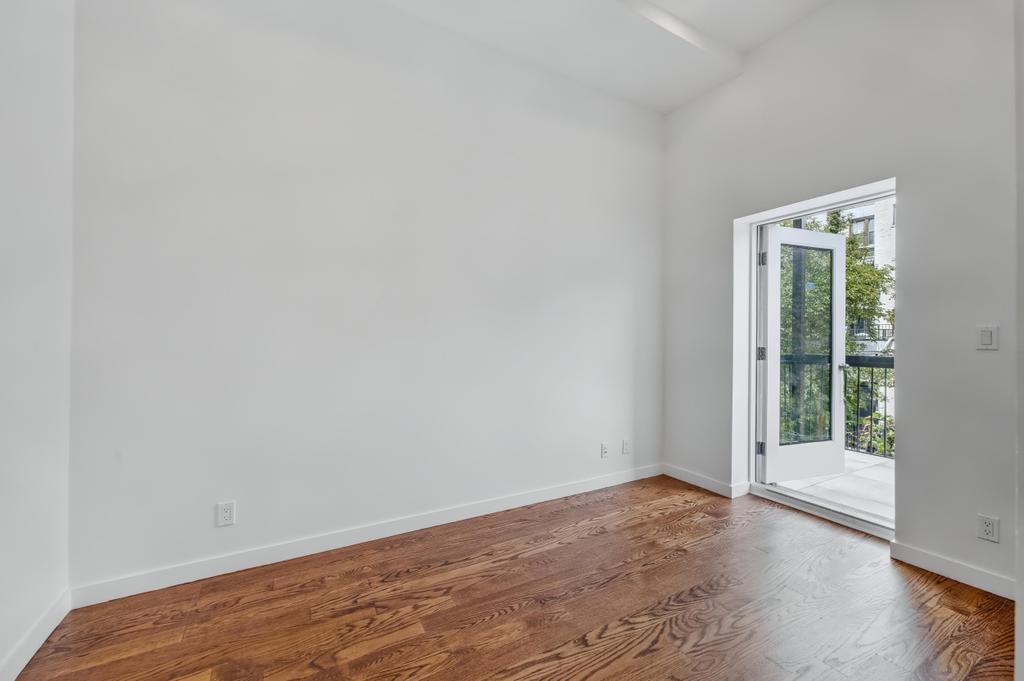 109 President Street, Unit 2 Brooklyn, NY 11231 - Photo 16 of 20 a view of an empty room with wooden floor and a window