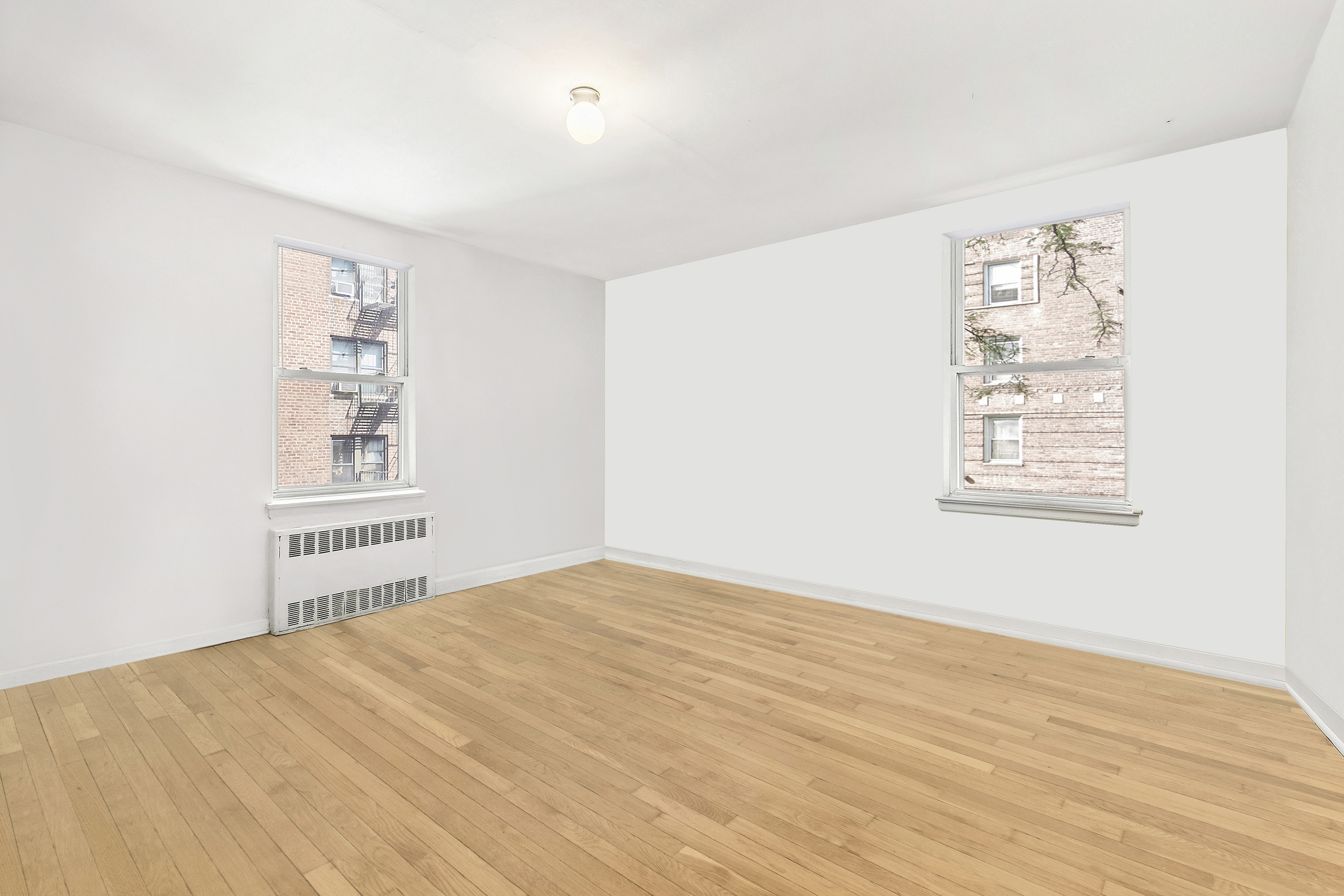 102-55 67th Drive, Unit 2C Queens, NY 11375 - Photo 4 of 6 a view of an empty room with a window