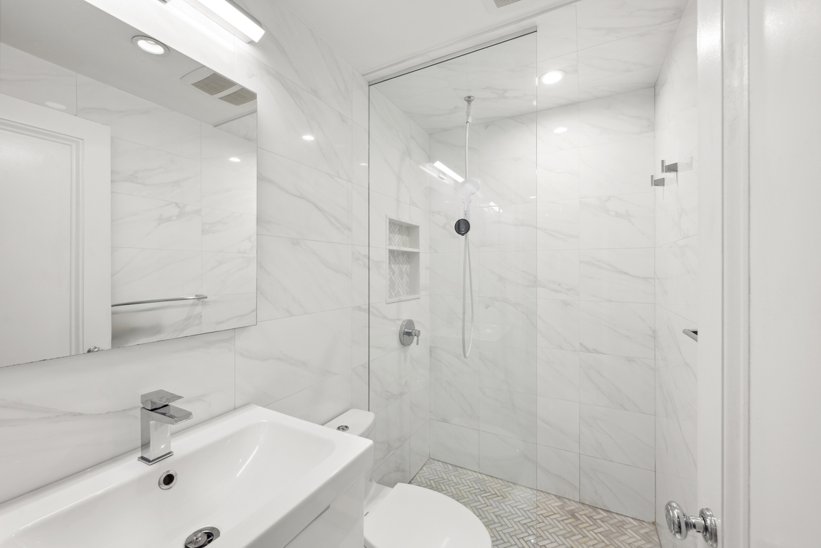 160 East 26th Street, Unit 6B Manhattan, NY 10010 - Photo 8 of 10 a bathroom with a sink toilet and shower