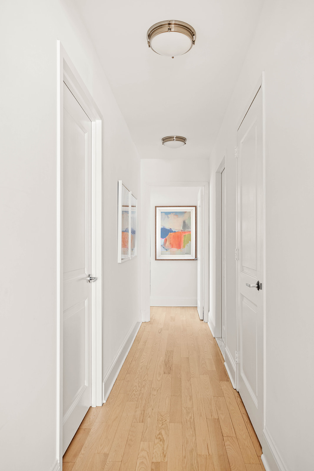 300 East 64th Street, Unit 26B Manhattan, NY 10065 - Photo 14 of 26 a view of a hallway with wooden floor