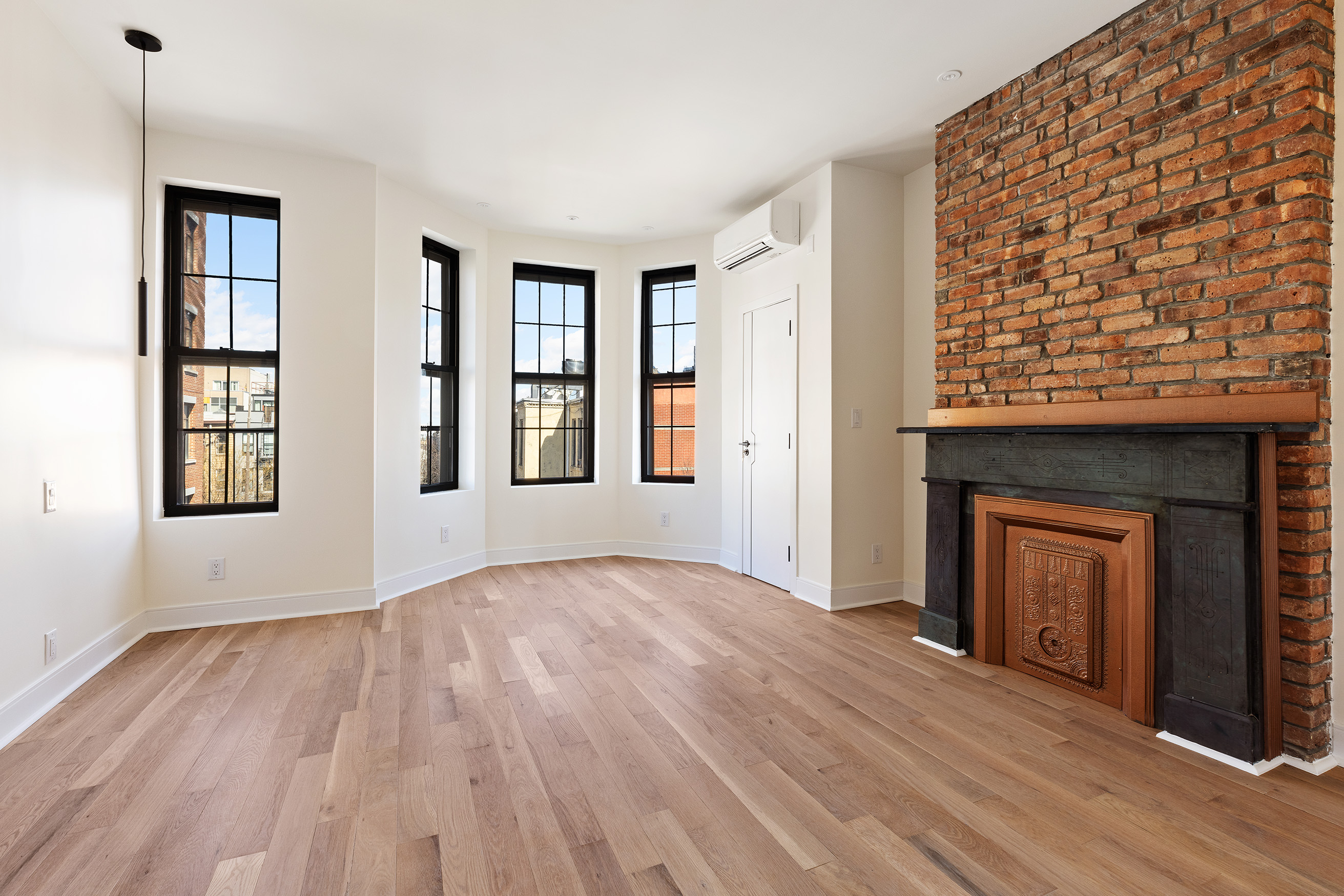 152 North 10th Street, Unit 2L Brooklyn, NY 11249 - Photo 9 of 12 a view of an empty room with window and wooden floor