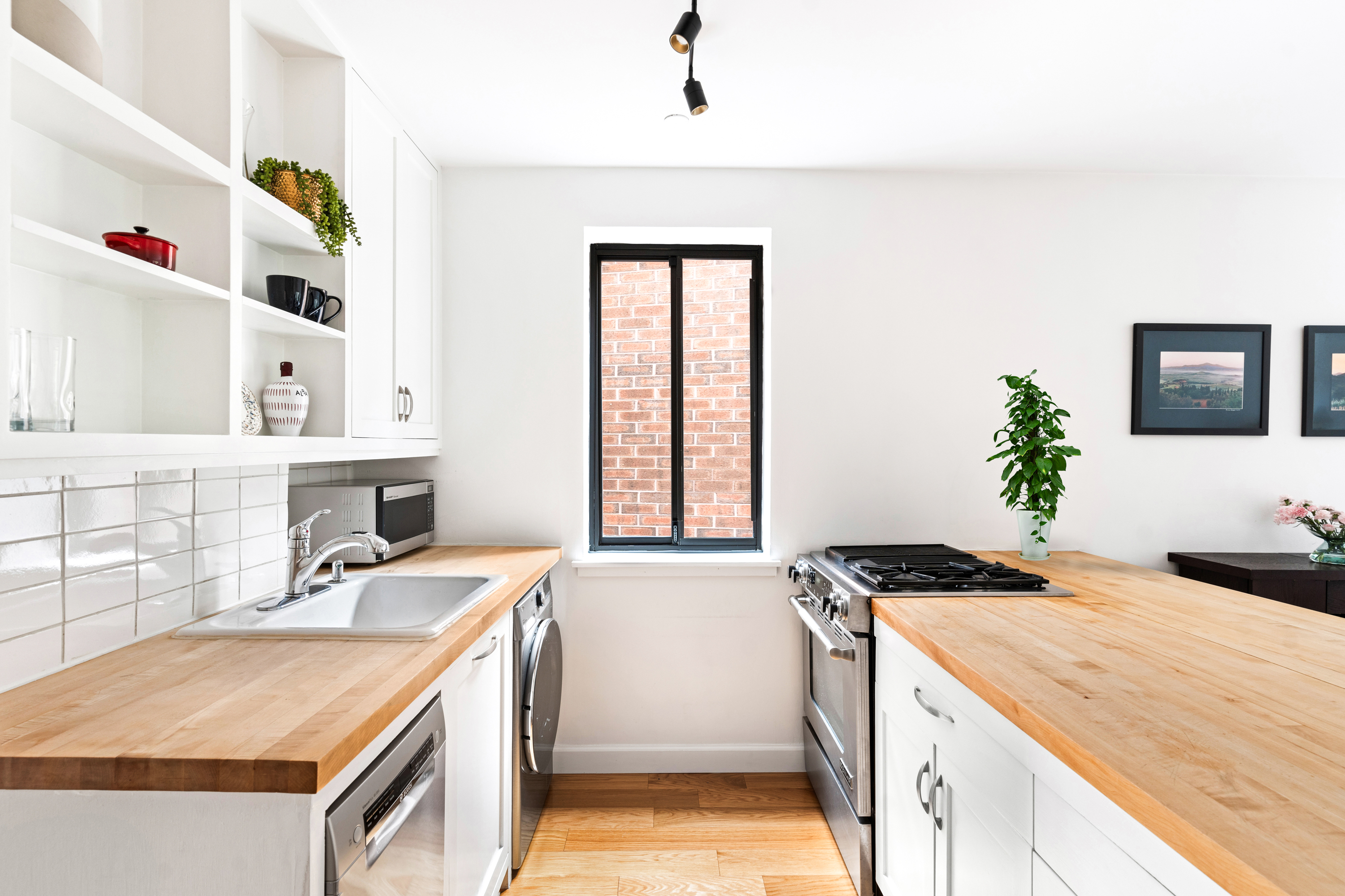 164 Bank Street, Unit 5B Manhattan, NY 10014 - Photo 6 of 11 a kitchen that has a sink and a stove